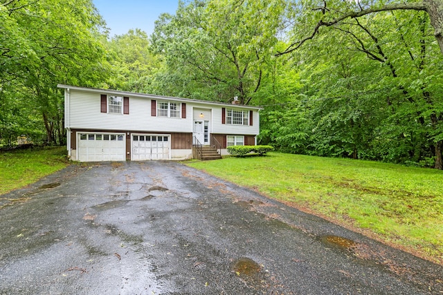 108 Gallivan Ln, Montville, CT 06382 - split foyer home featuring driveway, entry steps, a forest view, and a front yard