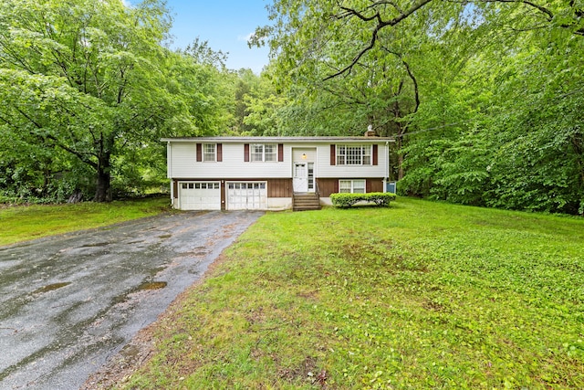 108 Gallivan Ln, Montville, CT 06382 - raised ranch featuring driveway, an attached garage, a front lawn, a chimney, and a forest view