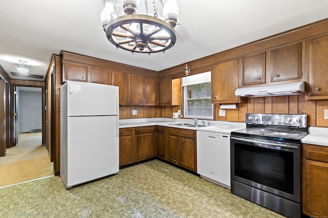108 Gallivan Ln, Montville, CT 06382 - kitchen featuring white appliances, under cabinet range hood, a chandelier, light floors, and light countertops