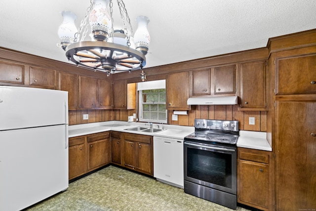 108 Gallivan Ln, Montville, CT 06382 - kitchen with white appliances, a sink, a chandelier, under cabinet range hood, and light countertops