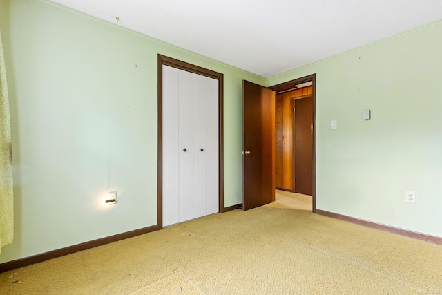 108 Gallivan Ln, Montville, CT 06382 - unfurnished bedroom featuring a closet, light carpet, baseboards, and ornamental molding