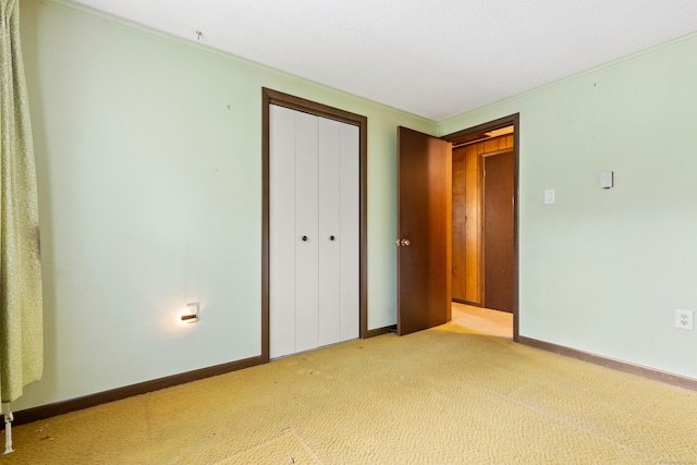 108 Gallivan Ln, Montville, CT 06382 - unfurnished bedroom with a closet, light colored carpet, baseboards, and crown molding