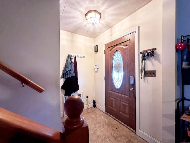 29 Hooker Rd, Bridgeport, CT 06610 - entrance foyer with baseboards, light tile patterned floors, and a textured ceiling