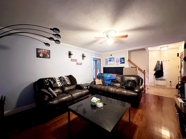 29 Hooker Rd, Bridgeport, CT 06610 - living room with radiator heating unit, a ceiling fan, wood finished floors, crown molding, and stairway