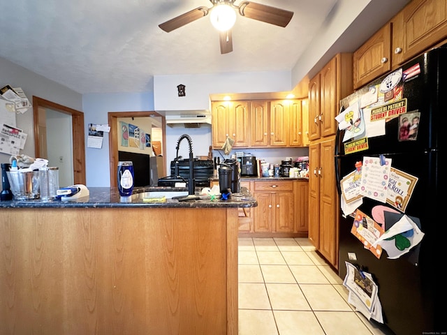 29 Hooker Rd, Bridgeport, CT 06610 - kitchen featuring freestanding refrigerator, ceiling fan, light tile patterned floors, a sink, and a peninsula
