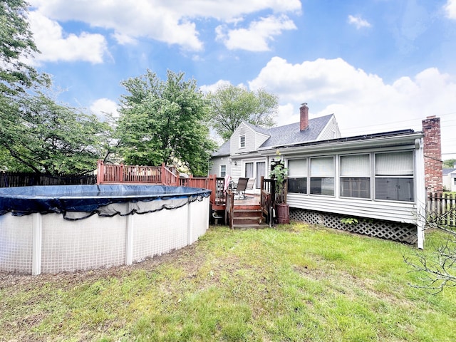 29 Hooker Rd, Bridgeport, CT 06610 - back of property featuring a wooden deck, a chimney, and a shingled roof