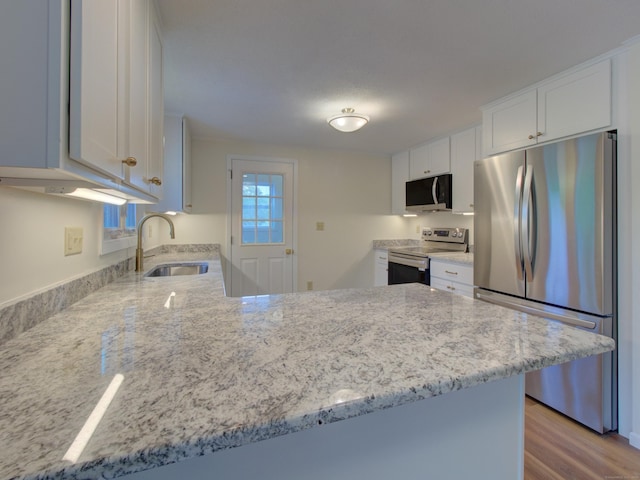 33 Homestead Rd, Ledyard, CT 06339 - kitchen featuring stainless steel appliances, a sink, a peninsula, light stone countertops, and white cabinets
