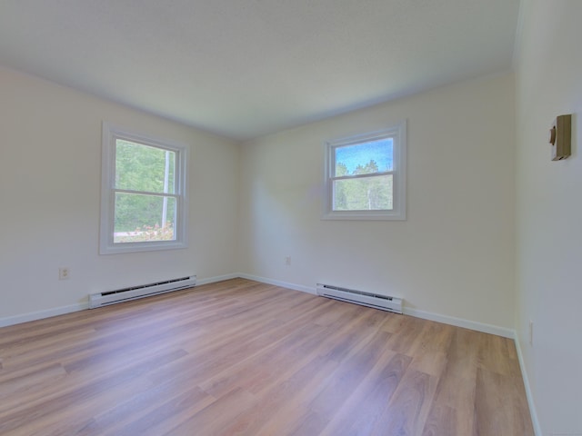 33 Homestead Rd, Ledyard, CT 06339 - empty room featuring a baseboard heating unit, plenty of natural light, and light wood-style flooring