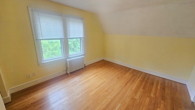 19 Weymouth Rd, Enfield, CT 06082 - bonus room with radiator, wood finished floors, vaulted ceiling, and baseboards