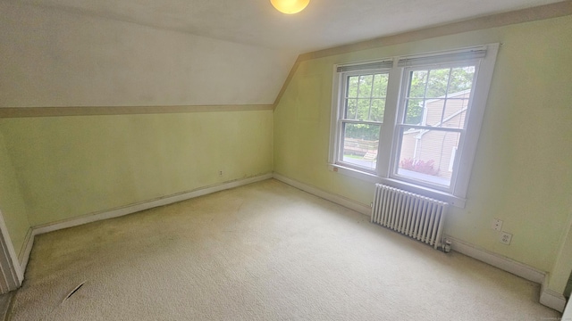 19 Weymouth Rd, Enfield, CT 06082 - additional living space featuring radiator heating unit, light colored carpet, vaulted ceiling, and baseboards