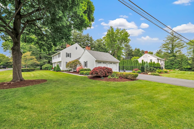 59 Ledyard Rd, West Hartford, CT 06117 - colonial house featuring asphalt driveway and an attached garage