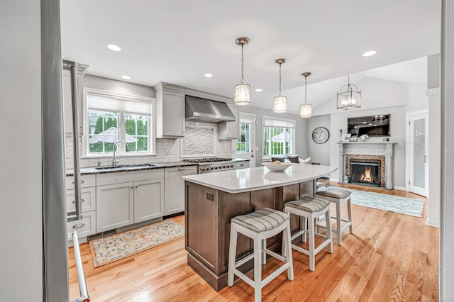 59 Ledyard Rd, West Hartford, CT 06117 - kitchen with a sink, wall chimney exhaust hood, open floor plan, tasteful backsplash, and a kitchen island