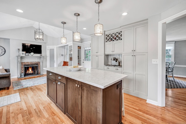 59 Ledyard Rd, West Hartford, CT 06117 - kitchen featuring light wood-style flooring, plenty of natural light, a kitchen island, open floor plan, and vaulted ceiling