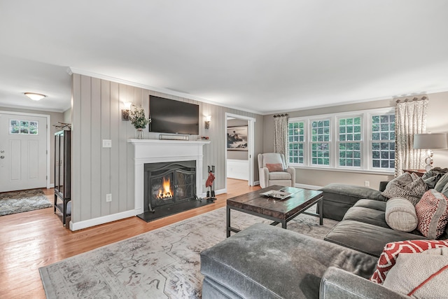 59 Ledyard Rd, West Hartford, CT 06117 - living room featuring crown molding, plenty of natural light, wood finished floors, a lit fireplace, and baseboards