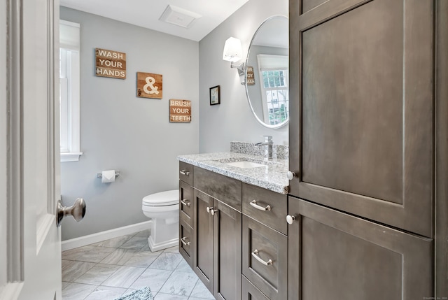 59 Ledyard Rd, West Hartford, CT 06117 - bathroom with toilet, vanity, marble finish flooring, and baseboards
