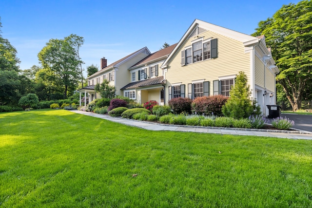 96 Norrans Ridge Dr, Ridgefield, CT 06877 - view of front of property featuring a chimney, a front lawn, a garage, and a standing seam roof