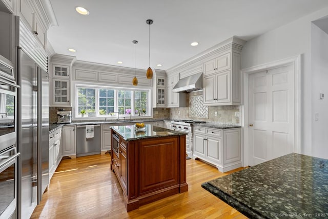 96 Norrans Ridge Dr, Ridgefield, CT 06877 - kitchen featuring ventilation hood, built in appliances, light wood-type flooring, backsplash, and glass insert cabinets