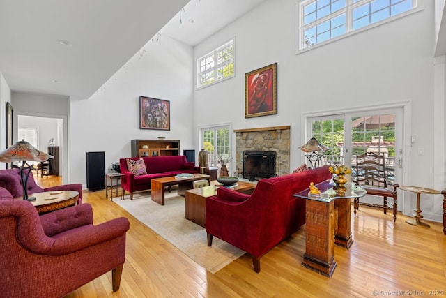 96 Norrans Ridge Dr, Ridgefield, CT 06877 - living area with a towering ceiling, light wood-type flooring, and a fireplace