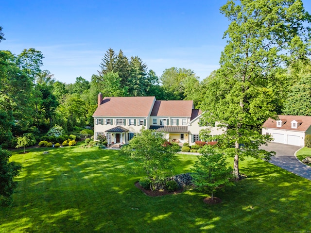 96 Norrans Ridge Dr, Ridgefield, CT 06877 - view of front of house with a front yard, a chimney, and a detached garage