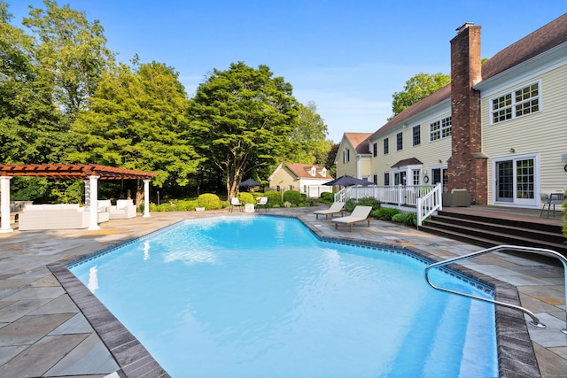 96 Norrans Ridge Dr, Ridgefield, CT 06877 - swimming pool with a pergola, a deck, and a patio