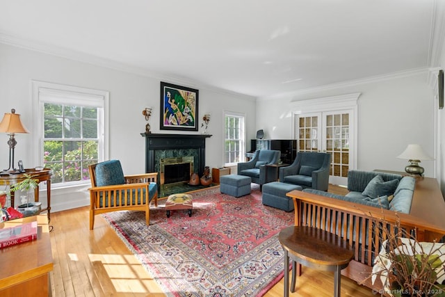 96 Norrans Ridge Dr, Ridgefield, CT 06877 - living area featuring healthy amount of natural light, ornamental molding, hardwood / wood-style floors, a fireplace with raised hearth, and french doors