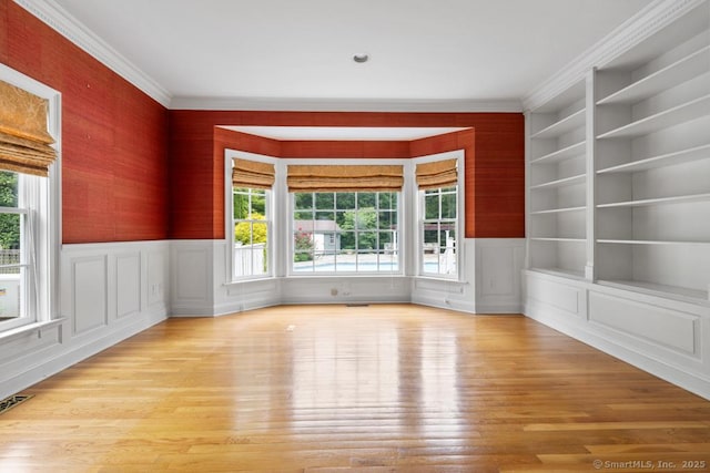 96 Norrans Ridge Dr, Ridgefield, CT 06877 - spare room with light wood-style flooring, wainscoting, built in shelves, crown molding, and a decorative wall