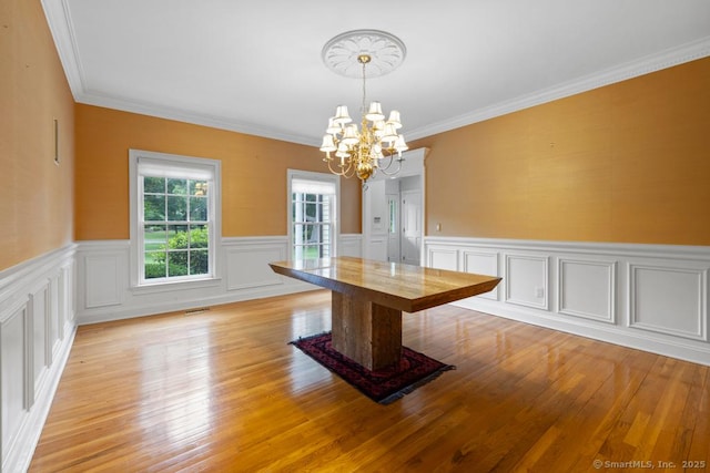 96 Norrans Ridge Dr, Ridgefield, CT 06877 - unfurnished dining area with a chandelier, ornamental molding, wainscoting, light wood-style flooring, and a decorative wall
