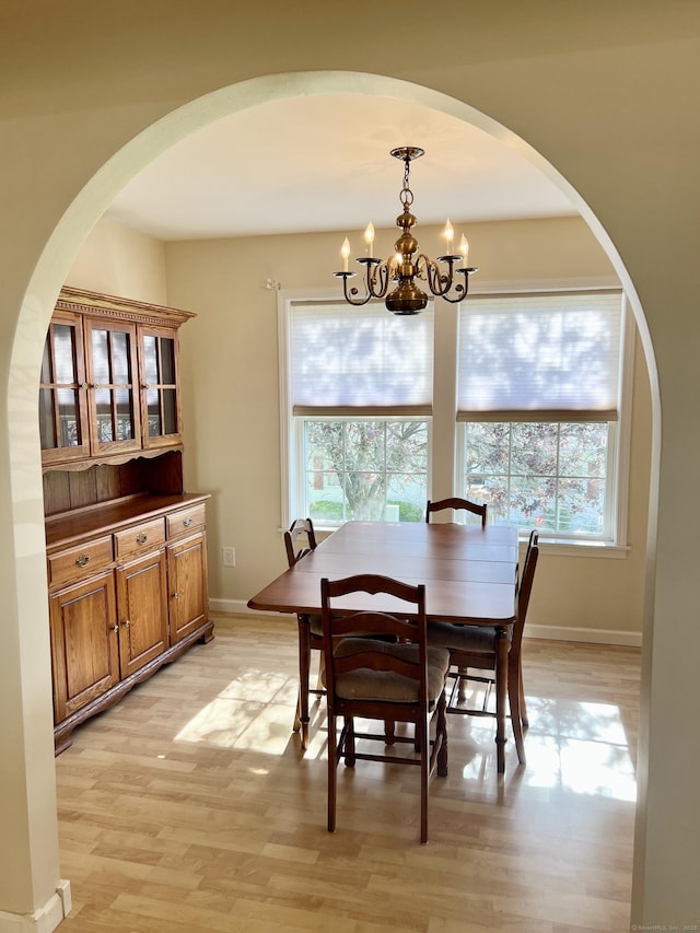 4 Cedar Grove Rd, Southington, CT 06489 - dining room with a chandelier, healthy amount of natural light, arched walkways, and light wood-style floors