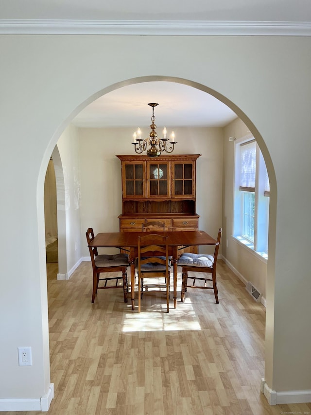 4 Cedar Grove Rd, Southington, CT 06489 - dining space featuring baseboards, light wood-type flooring, and arched walkways