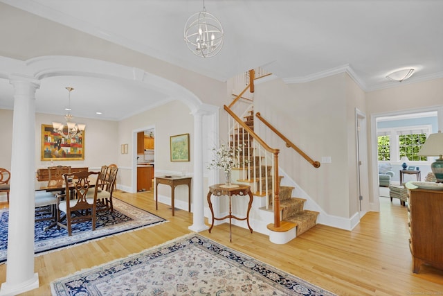 14 Withe Pass, Burlington, CT 06013 - dining area featuring a chandelier, arched walkways, decorative columns, stairs, and crown molding