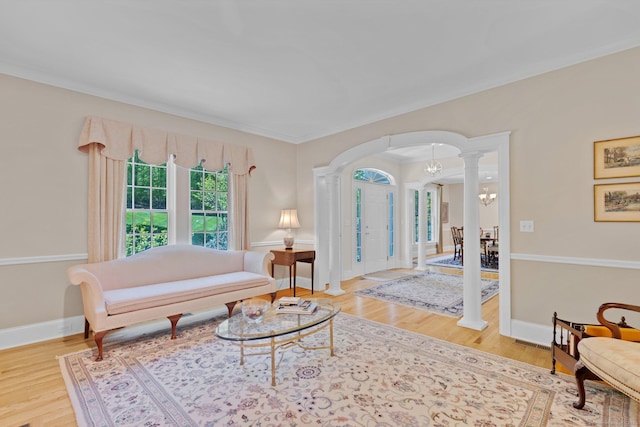 14 Withe Pass, Burlington, CT 06013 - living area featuring arched walkways, decorative columns, wood finished floors, and a chandelier