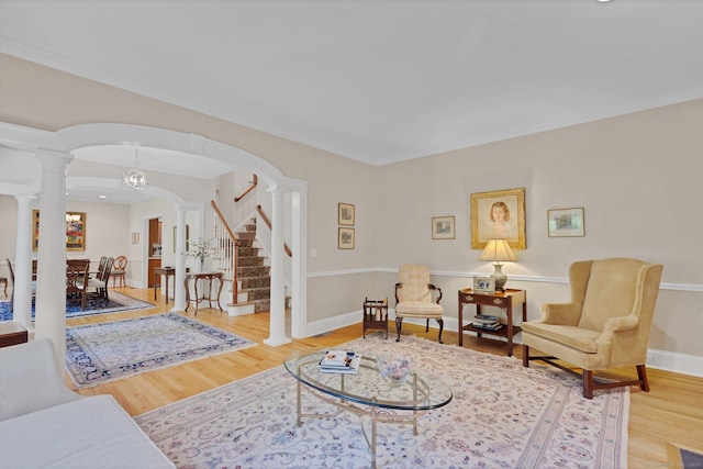 14 Withe Pass, Burlington, CT 06013 - living area with decorative columns, arched walkways, wood finished floors, stairway, and crown molding