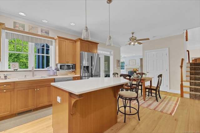 14 Withe Pass, Burlington, CT 06013 - kitchen featuring stainless steel appliances, a sink, a kitchen island, light wood-style floors, and ornamental molding