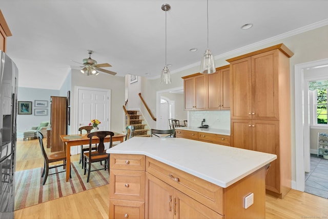 14 Withe Pass, Burlington, CT 06013 - kitchen with ceiling fan, light wood finished floors, light countertops, decorative backsplash, and a kitchen island