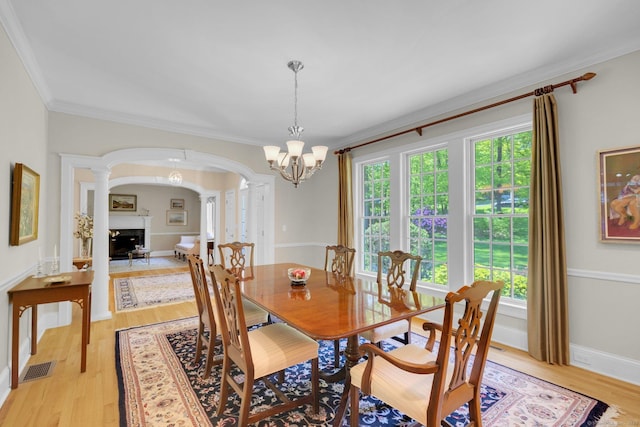 14 Withe Pass, Burlington, CT 06013 - dining room with arched walkways, ornamental molding, decorative columns, light wood-type flooring, and a chandelier