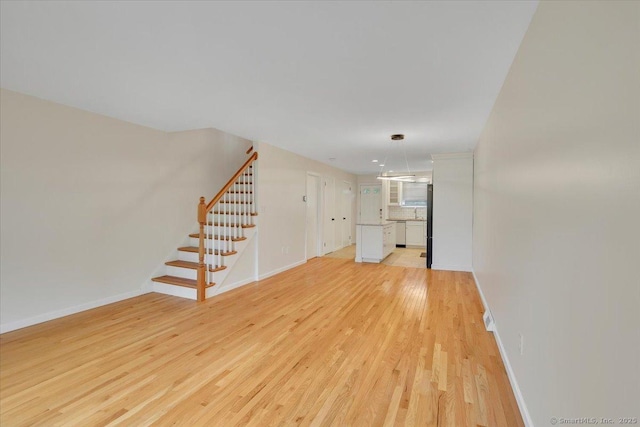 165 Hampton Ct Unit 165, Newington, CT 06111 - unfurnished living room with stairway, light wood-style flooring, and baseboards