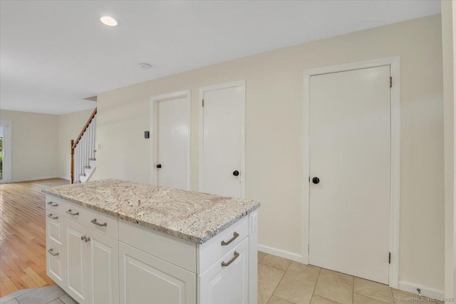 165 Hampton Ct Unit 165, Newington, CT 06111 - kitchen featuring baseboards, light stone counters, white cabinetry, recessed lighting, and a kitchen island