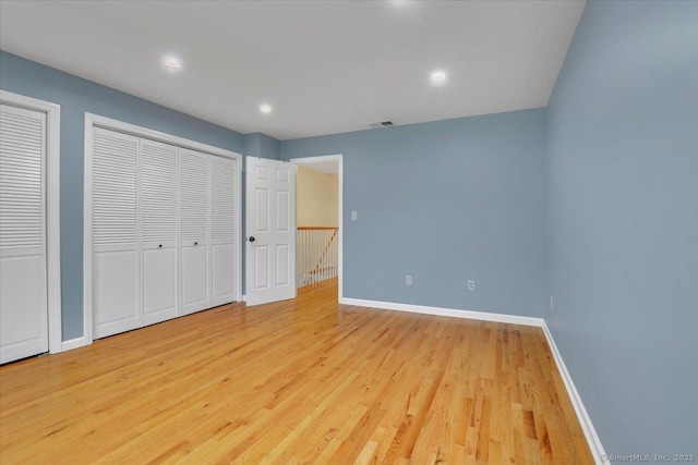165 Hampton Ct Unit 165, Newington, CT 06111 - unfurnished bedroom with wood finished floors, baseboards, multiple closets, and recessed lighting
