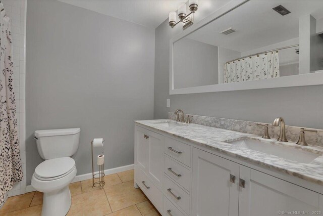165 Hampton Ct Unit 165, Newington, CT 06111 - full bath with double vanity, tile patterned flooring, toilet, baseboards, and a shower with shower curtain