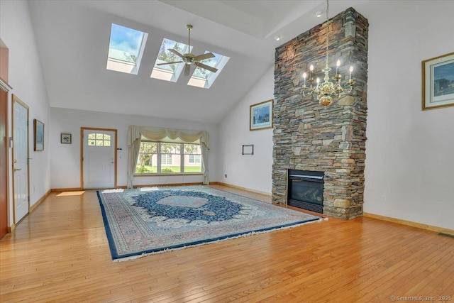 503 Dzen Way Unit 503, South Windsor, CT 06074 - unfurnished living room with high vaulted ceiling, wood-type flooring, a skylight, and a stone fireplace