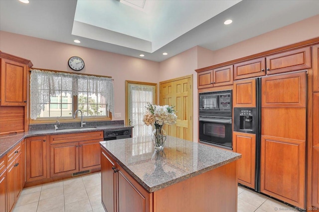 503 Dzen Way Unit 503, South Windsor, CT 06074 - kitchen featuring black appliances, light tile patterned floors, brown cabinetry, a kitchen island, and dark stone countertops