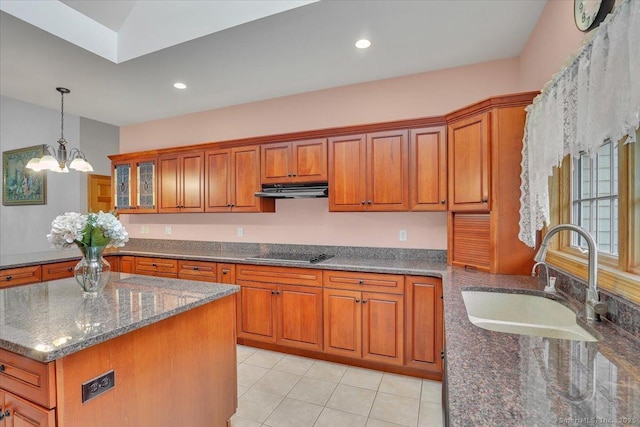 503 Dzen Way Unit 503, South Windsor, CT 06074 - kitchen with brown cabinets, under cabinet range hood, black electric stovetop, dark stone countertops, and light tile patterned floors