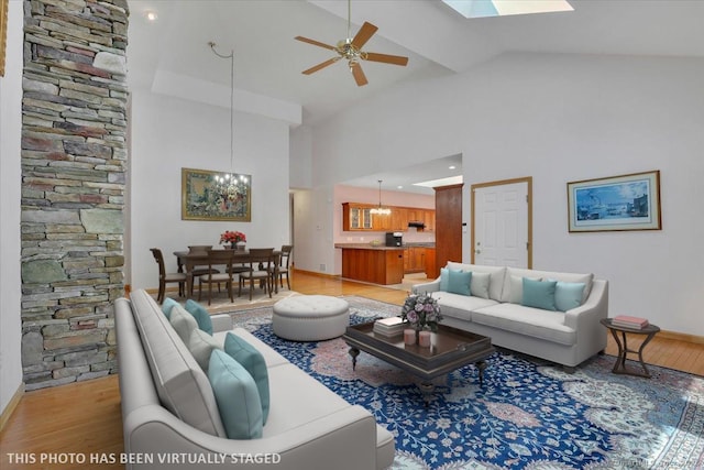 503 Dzen Way Unit 503, South Windsor, CT 06074 - living room featuring a chandelier, high vaulted ceiling, light wood finished floors, ceiling fan, and a skylight