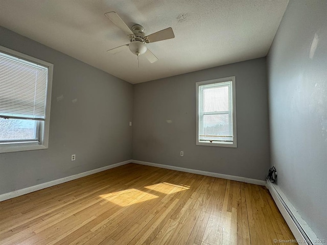 220 Kensington Ave, New Britain, CT 06051 - spare room with baseboard heating, light wood finished floors, baseboards, and a ceiling fan