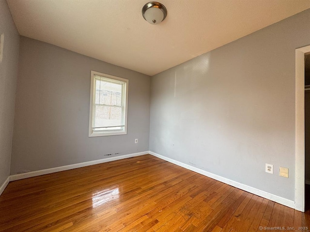220 Kensington Ave, New Britain, CT 06051 - unfurnished room with wood-type flooring and baseboards