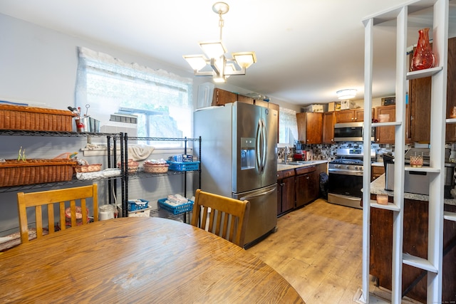 165 Scantic Meadow Rd, South Windsor, CT 06074 - kitchen featuring stainless steel appliances, a sink, light wood-type flooring, light countertops, and backsplash