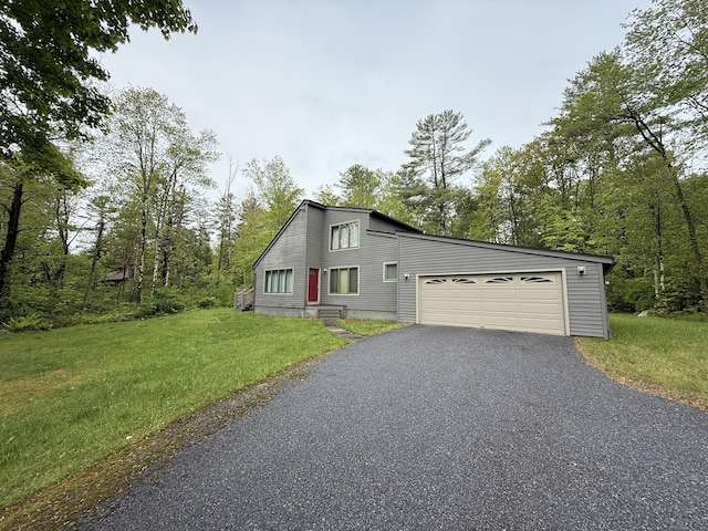 53 Bentley Cir, Goshen, CT 06756 - view of front of house featuring asphalt driveway, a front yard, and an attached garage