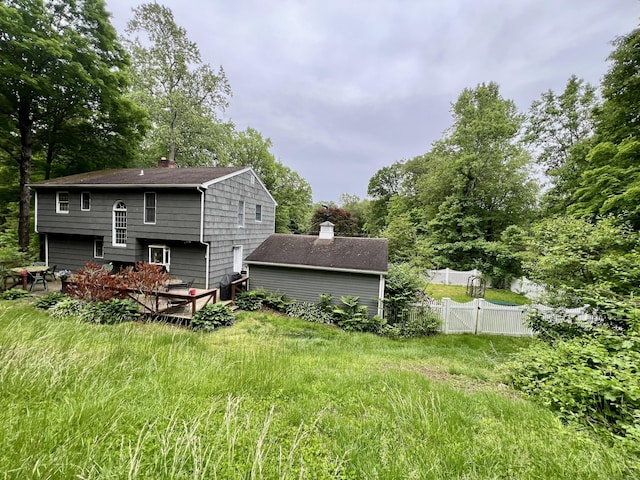 28 Blakeman Dr, Monroe, CT 06468 - rear view of house featuring a chimney, view of wooded area, and roof with shingles
