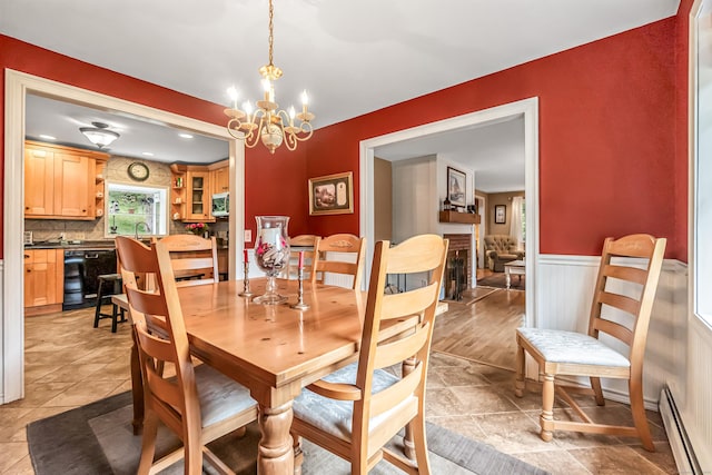 28 Blakeman Dr, Monroe, CT 06468 - dining space featuring a baseboard heating unit, a wainscoted wall, a chandelier, and light tile patterned flooring