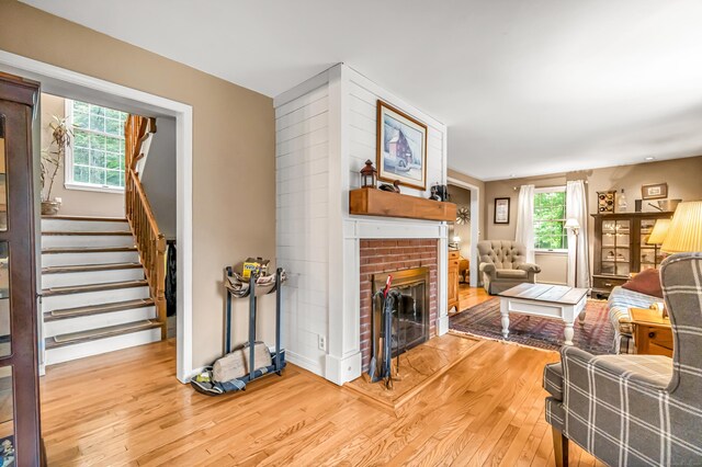 28 Blakeman Dr, Monroe, CT 06468 - living room featuring light wood-type flooring, a fireplace, and stairs